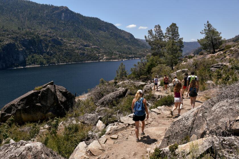 A 5-mile trail (round-trip) leads from the Hetch Hetchy Valley's O'Shaughnessy Dam to Wapama Falls in Yosemite National Park. The route skirts the edge of the Hetchy Hetchy Reservoir.