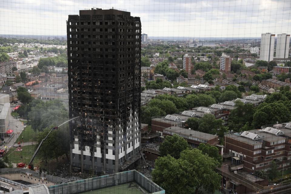 <p>A hose continues to douse the fire at Grenfell Tower on June 15, 2017 in London, England. (Photo: Dan Kitwood/Getty Images) </p>