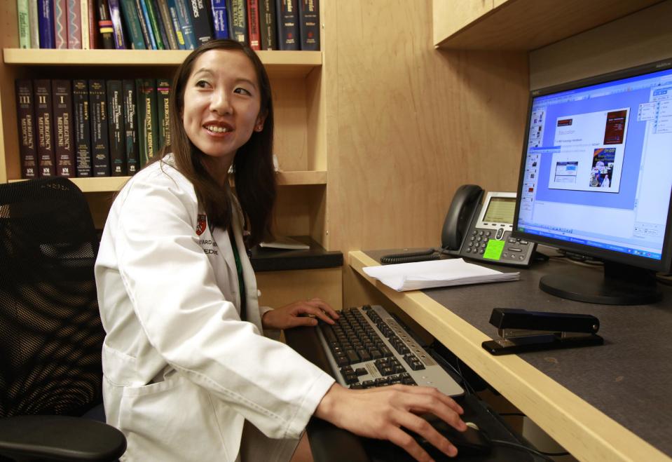 In this Tuesday, Aug. 14, 2012 photo Leana Wen, of Boston, who is doing her medical residency in emergency medicine at Harvard-affiliated Brigham and Women's Hospital and Massachusetts General Hospital, works on a computer at Brigham and Women's in Boston. Wen chose emergency medicine because the hours are more flexible than those of primary care physicians. (AP Photo/Steven Senne)