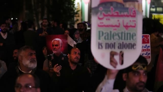 A demonstrator holds a poster of the late Iranian Revolutionary Guard Gen. Qassem Soleimani