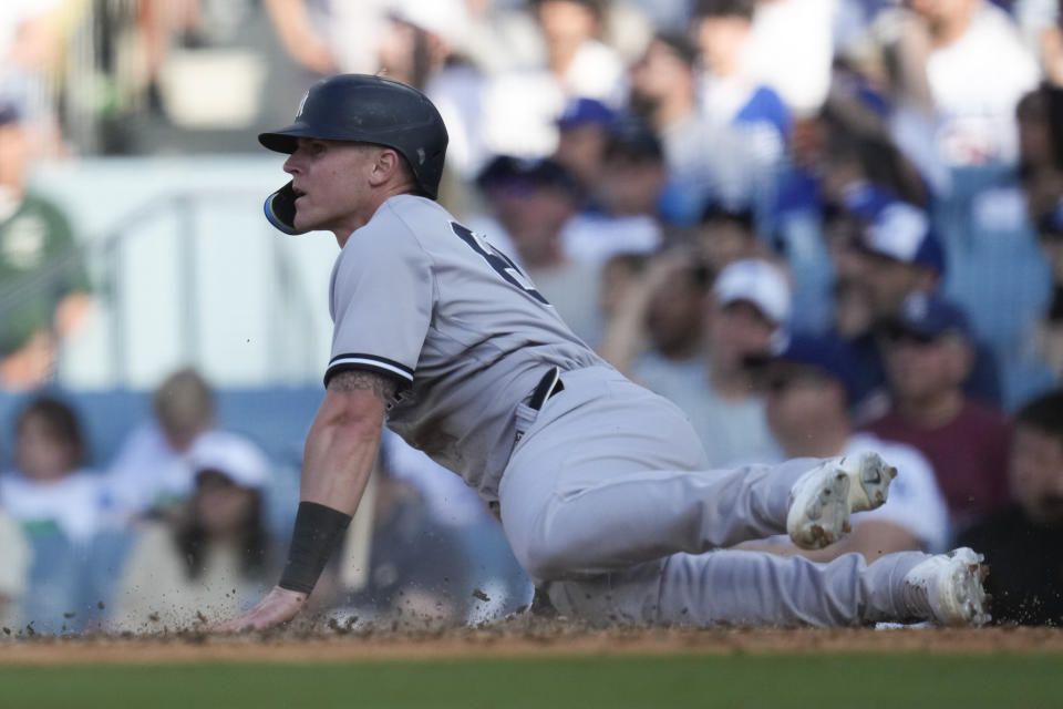New York Yankees' Jake Bauers (61) scores off of a ground out by Kyle Higashioka during the seventh inning of a baseball game against the Los Angeles Dodgers in Los Angeles, Sunday, June 4, 2023. (AP Photo/Ashley Landis)