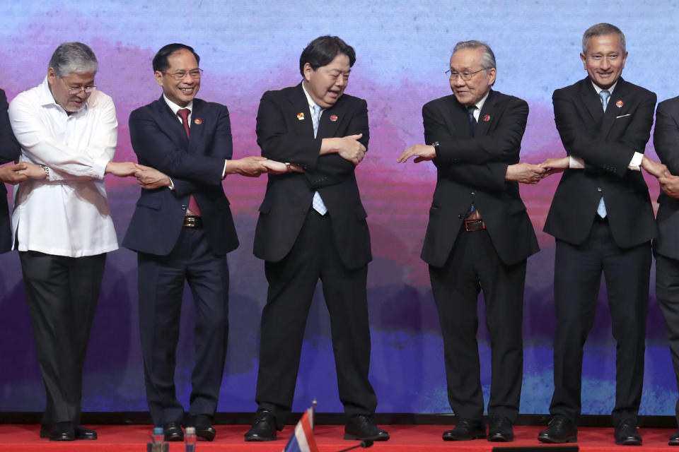 From left to right, Philippine's Foreign Secretary Enrique Manalo, Vietnam's Foreign Minister Bui Thanh Son, Japan's Foreign Minister Yoshimasa Hayashi, Thailand's Foreign Minister Don Pramudwinai and Singapore's Foreign Minister Vivian Balakrishnan hold hands for a group photo session during the ASEAN Post Ministerial Conference with Japan at the Association of Southeast Asian Nations (ASEAN) Foreign Ministers' Meeting in Jakarta, Indonesia, Thursday, July 13, 2023. (Bagus Indahono/Pool Photo via AP)