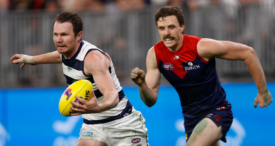 Jake Lever (pictured right) chases Patrick Dangerfield (pictured left) during the 2021 AFL First Preliminary Final match.