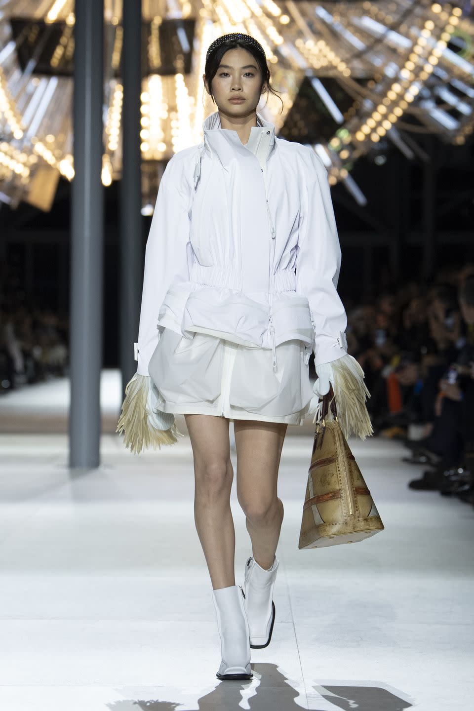 a woman walking down a runway