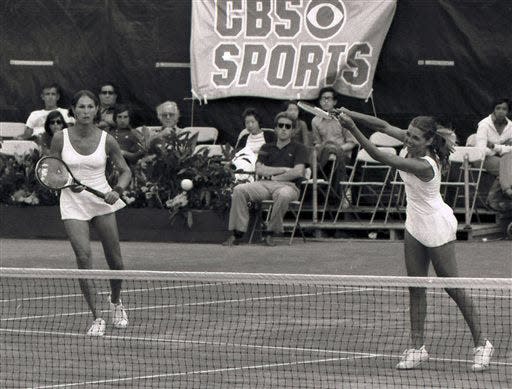 Renee Richards, left, watches as Betty Ann Stuart hits during the U.S. Open women's double championships against Betty Stove and Martina Navratilova in 1977.