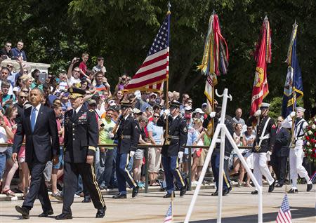 U.S. President Barack Obama walks with Major General Jeffrey S. Buchanan before placing a wreath at the Tomb of the Unknowns at Arlington National Cemetery in Virginia May 26, 2014. REUTERS/Joshua Roberts