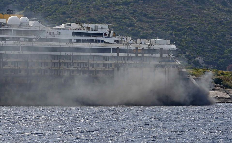 Black smoke comes out from the back of the Costa Concordia cruise liner during its refloat operation at Giglio harbour July 22, 2014. (REUTERS/Max Rossi)