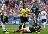 <p>Iranian referee Alireza Faghani (2ndL) talks to Germany’s goalkeeper Manuel Neuer (R) trying to help Mexico’s forward Javier Hernandez lying on the pitch during the Russia 2018 World Cup Group F football match between Germany and Mexico at the Luzhniki Stadium in Moscow on June 17, 2018. (Photo by Yuri CORTEZ / AFP) </p>