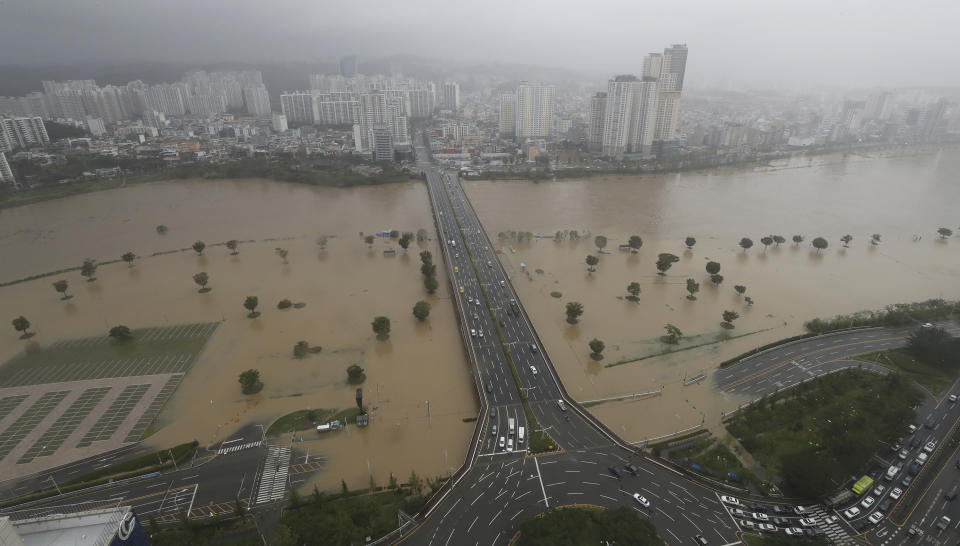 A part of a road and riverside near the Taehwa River are flooded due to heavy rain in Ulsan, South Korea, Monday, Sept. 7, 2020. A powerful typhoon damaged buildings, flooded roads and knocked out power to thousands of homes in South Korea on Monday after battering southern Japanese islands. More than 20 people were injured. (Kim Yong-tai/Yonhap via AP)