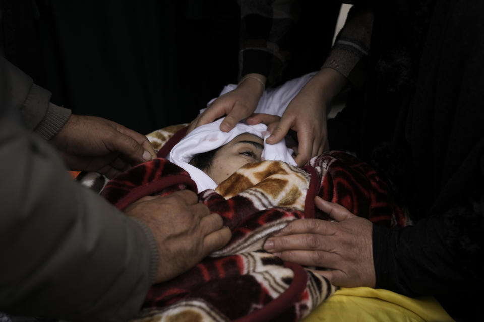 Mourners take a last look at the body of Palestinian Fulla al-Masalmeh,15, during her funeral in the West Bank village of Beit Awwa, Tuesday, Nov. 15, 2022. The Palestinian Health Ministry says Israeli forces shot and killed a 15-year-old Palestinian girl during a pre-dawn raid in the occupied West Bank. The circumstances surrounding the death of the teenage girl in the city of Beitunia in the central West Bank, identified by Palestinian health officials as Fulla al-Masalmeh, were not fully clear. The Israeli military said soldiers opened fire on a vehicle that was accelerating toward them after they signaled for it to stop. The military said it was investigating, and declined to comment further. (AP Photo/Mahmoud Illean)