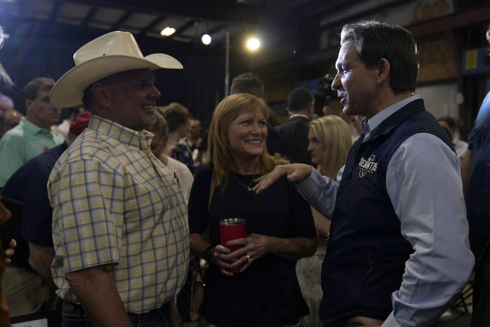 Republican presidential candidate Florida Gov. Ron DeSantis talks with an audience member during a campaign event at Port Neal Welding, Wednesday, May 31, 2023, in Salix, Iowa. (AP Photo/Charlie Neibergall)