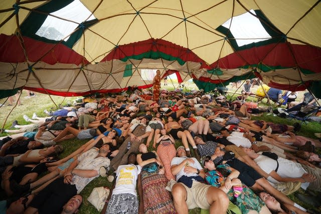 Festival-goers take part in a laughter yoga workshop in the Healing Field during the Glastonbury Festival at Worthy Farm in Somerset