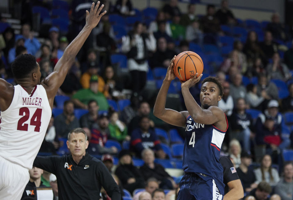 Connecticut guard Nahiem Alleyne, right, looks to shoot over Alabama forward Brandon Miller during the first half of an NCAA college basketball game in the Phil Knight Invitational tournament in Portland, Ore., Friday, Nov. 25, 2022. (AP Photo/Craig Mitchelldyer)