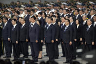 Chinese President Xi Jinping, center, and other officials sing the Chinese national anthem during a ceremony to mark Martyr's Day at Tiananmen Square in Beijing, Monday, Sept. 30, 2019. Xi led other top officials in paying respects to the founder of the communist state Mao Zedong ahead of a massive celebration of the People's Republic's 70th anniversary. (AP Photo/Mark Schiefelbein, Pool)