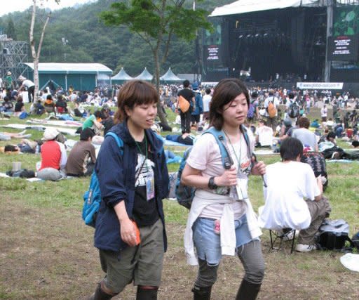 Two Japanese music fans at the Fuji Rock festival in 2006. The feuding Gallagher brothers may not be speaking to each other after their acrimonious Oasis split three years ago, but they will share the bill at this weekend's Fuji Rock festival in Japan