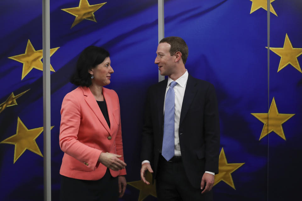 Facebook CEO Mark Zuckerberg, right, is greeted by European Commissioner for Values and Transparency Vera Jourova prior to a meeting at EU headquarters in Brussels, Monday, Feb. 17, 2020. (AP Photo/Francisco Seco)