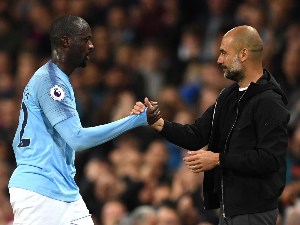 Happier times: Manchester City boss Pep Guardiola and Yaya Toure before the race row