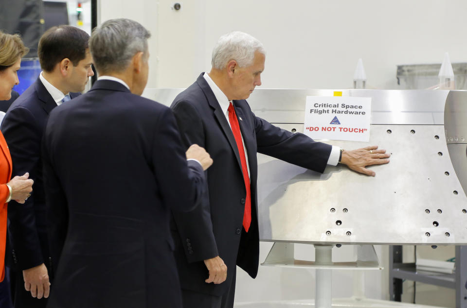 Mike Pence ignored a "Do No Touch" sign on a piece of hardware during a tour of the Kennedy Space Center's Operations and Checkout Building on Thursday. (Photo: Mike Brown / Reuters)