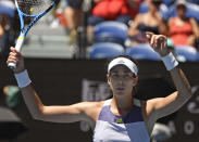 Spain's Garbine Muguruza waves after defeating Russia's Anastasia Pavlyuchenkova in their quarterfinal match at the Australian Open tennis championship in Melbourne, Australia, Wednesday, Jan. 29, 2020. (AP Photo/Andy Brownbill)