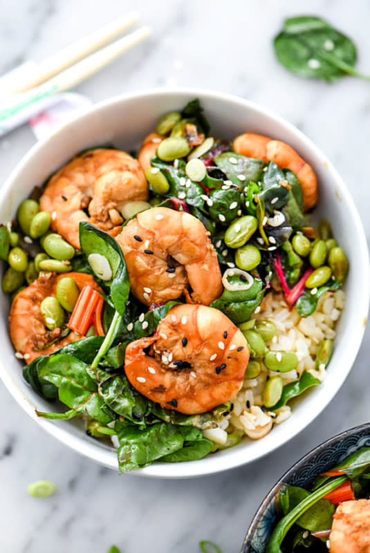 <p>Foodie Crush</p><p>This sesame shrimp stir fry with Swiss chard, edamame and spinach, and served over brown rice for a quick, easy and healthy recipe for a weeknight dinner!</p><p><strong>Get the recipe: <a href="https://www.foodiecrush.com/sesame-shrimp-asian-greens-rice-bowl/" rel="nofollow noopener" target="_blank" data-ylk="slk:Sesame Shrimp and Asian Greens Rice Bowl;elm:context_link;itc:0;sec:content-canvas" class="link rapid-noclick-resp">Sesame Shrimp and Asian Greens Rice Bowl</a></strong></p>