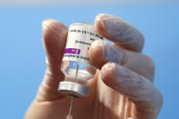 FILE - In this Thursday, Feb. 11, 2021 file photo, a health worker prepares a dose of a COVID-19 vaccine to be administered at a center set up in Fiumicino, near Rome's international airport. On Friday, March 5, 2021, The Associated Press reported on stories circulating online incorrectly asserting there is absolutely no need for vaccines to extinguish the pandemic and people who aren’t at risk from the disease should not be vaccinated. A misleading quote written in a U.K.-based blog in October 2020 by Michael Yeadon, a retired British doctor who previously worked for Pfizer, found new life on Facebook this week, circulating on a widely shared post. (AP Photo/Alessandra Tarantino)