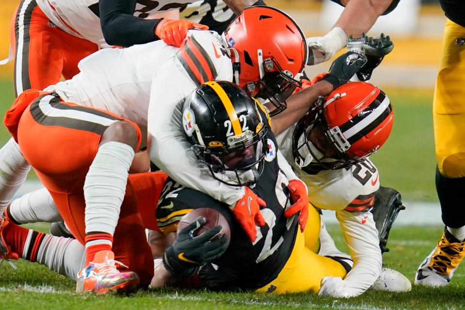 Pittsburgh Steelers running back Najee Harris (22) is hit by Cleveland Browns cornerback Greg Newsome II (20) as he runs the ball in the first half of an NFL football game, Monday, Jan. 3, 2022, in Pittsburgh. (AP Photo/Gene J. Puskar)