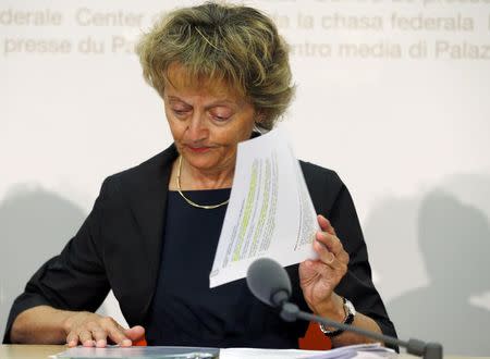 Swiss Finance Minister Eveline Widmer-Schlumpf sorts her documents before a news conference after the weekly meeting of the Federal Council in Bern, Switzerland July 1, 2015. REUTERS/Ruben Sprich