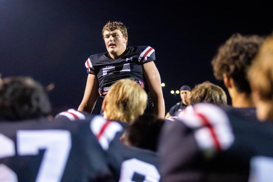 West Ottawa's Cooper Terpstra talks with his team after thier loss to Grand Haven Friday, Sept. 17, 2021 at West Ottawa's Panthers Stadium. 