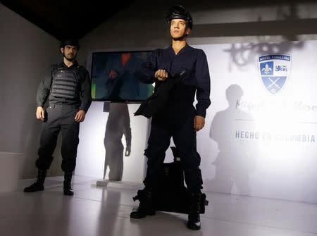 Models present bulletproof clothing and equipment by the Miguel Caballero Factory at the Chico Museum in Bogota, Colombia, June 24, 2016. REUTERS/John Vizcaino