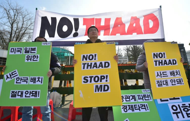 Anti-war activists hold placards during a rally against talks on deployment of the US-built Terminal High Altitude Area Defense, THAAD, outside South Korea's defence ministry in Seoul on March 4, 2016