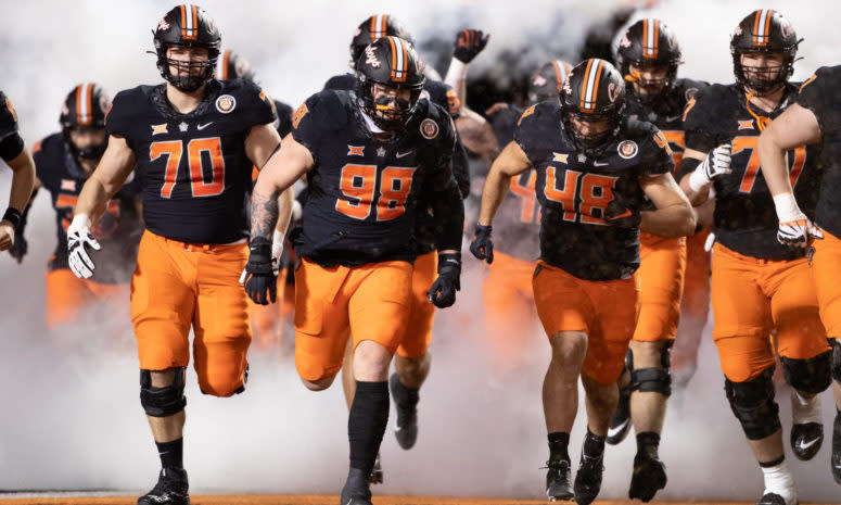 Oklahoma State players run out onto the field.