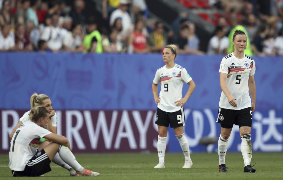 Germany's Marina Hegering, right, with teammates reacts after loosing the Women's World Cup quarterfinal soccer match between Germany and Sweden at Roazhon Park in Rennes, France, Saturday, June 29, 2019. Sweden beat Germany 2-1. (AP Photo/David Vincent)