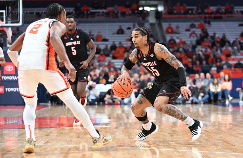 Louisville guard Skyy Clark tries to drive past Syracuse guard J.J. Starling in the first half. Clark scored a team-high 23 points Wednesday night.