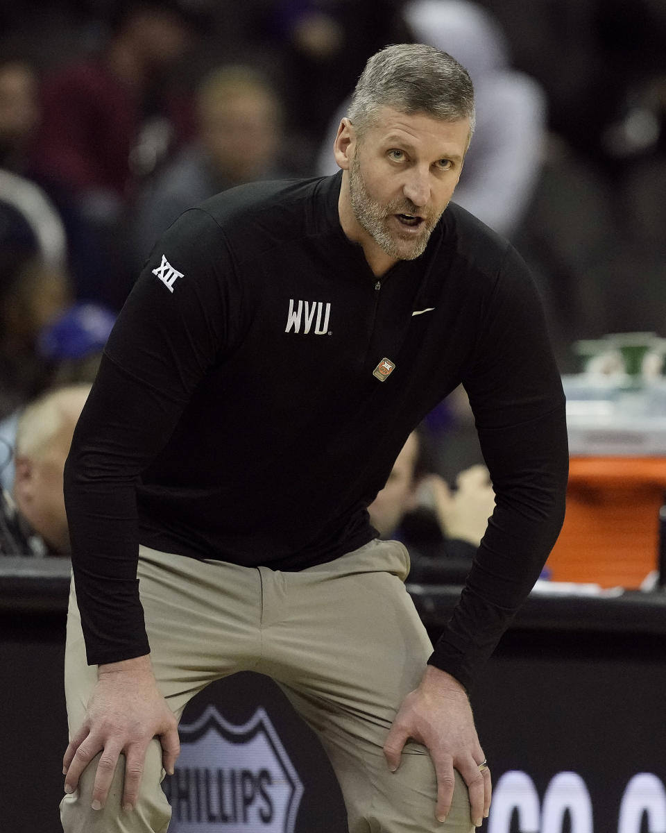 West Virginia head coach Josh Eilert talks to his team during the second half of an NCAA college basketball game against Cincinnati Tuesday, March 12, 2024, in Kansas City, Mo. Cincinnati won 90-85. (AP Photo/Charlie Riedel)