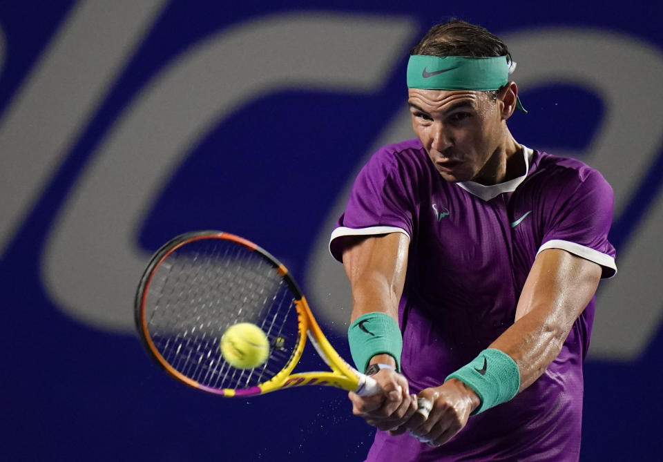 Rafael Nadal of Spain returns a ball during a match against to Denis Kudla of the U.S. at the Mexican Open tennis tournament in Acapulco, Mexico, Tuesday, Feb. 22, 2022. (AP Photo/Eduardo Verdugo)