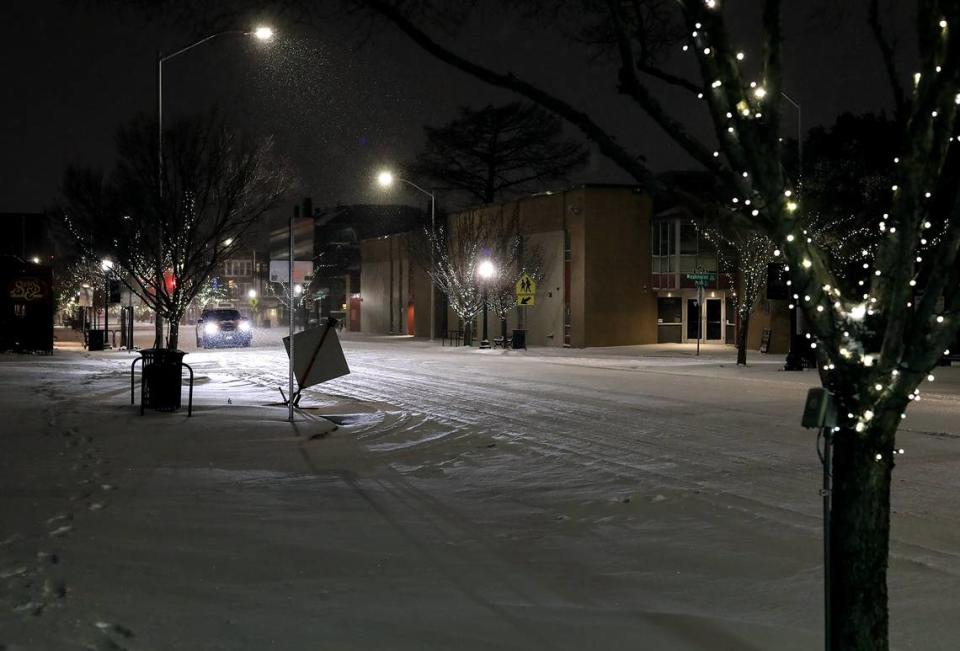 A Fort Worth Police Department patrol vehicle makes its way down Magnolia Avenue on Sunday evening, February 14, 2021. Winter Storm Uri brought significant snow to North Texas which is expected to continue into Monday.