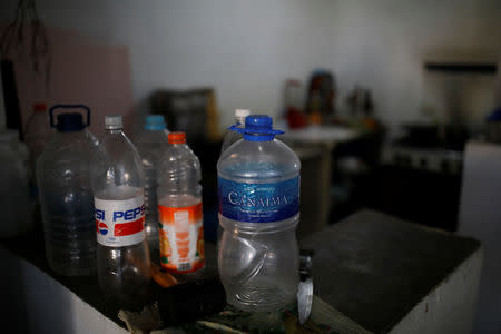 Empty plastic bottles used to collect water are stored in the kitchen of Wilson Hernandez, who lives on the 4th floor of an apartment block in downtown Caracas, Venezuela, March 18, 2019. REUTERS/Carlos Garcia Rawlins