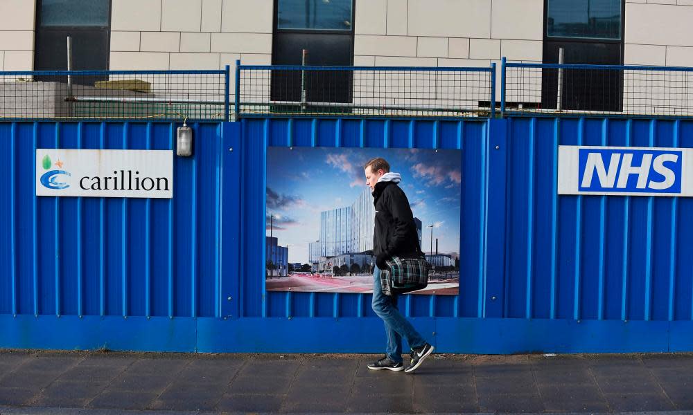 A pedestrian walks past Carillion’s Royal Liverpool University Hospital construction site