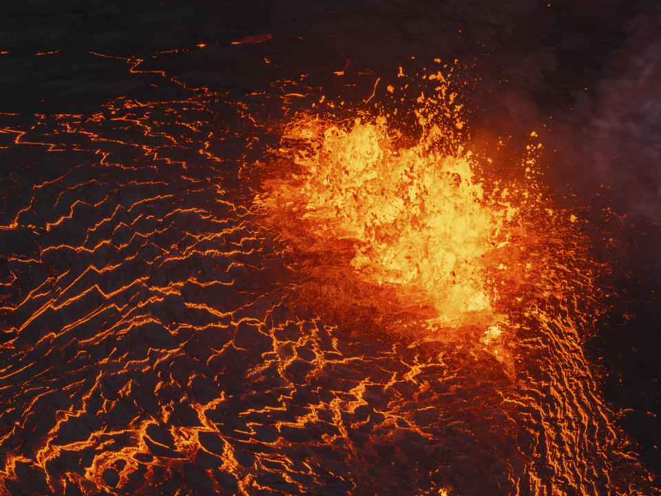 Lava flows from a volcano in Grindavik, Iceland, Wednesday, May 29, 2024. A volcano in southwestern Iceland erupted Wednesday for the fifth time since December, spewing red lava that once again threatened the coastal town of Grindavik and led to the evacuation of the popular Blue Lagoon geothermal spa. (AP Photo/Marco di Marco)