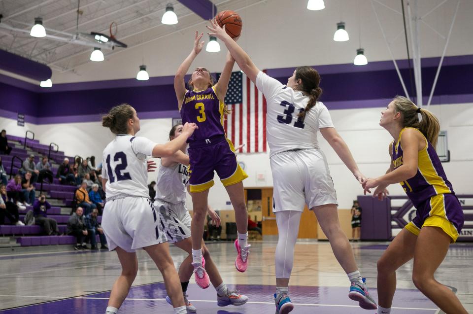 Bloom-Carroll's Emily Bratton drives for a layup against Logan on Nov. 28.