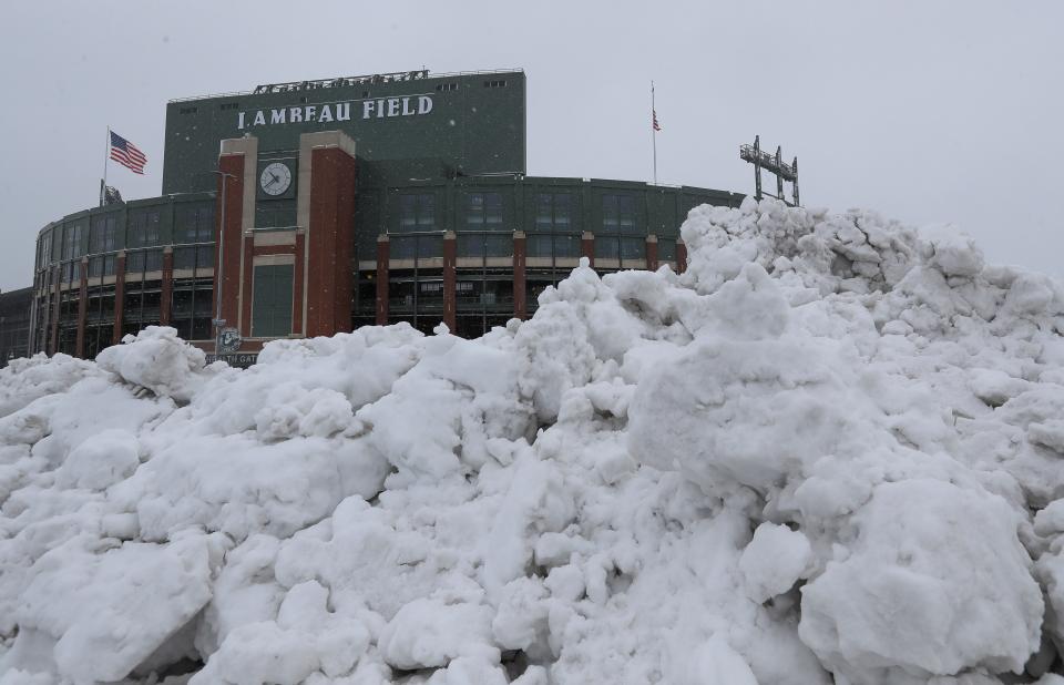 Snow is piled up on Wednesday outside at Lambeau Field in Green Bay.