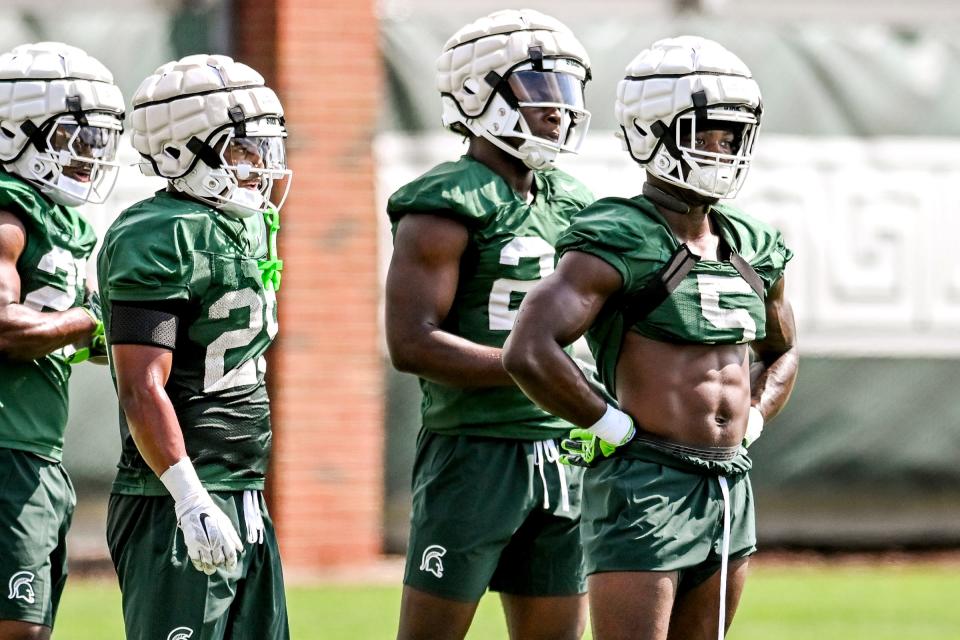 From left, Michigan State running backs Makhi Frazier, Joseph Martinez, Shawn Foster and Nathan Carter look on during a break in the action on the first day of football camp on Tuesday, July 30, 2024, in East Lansing.