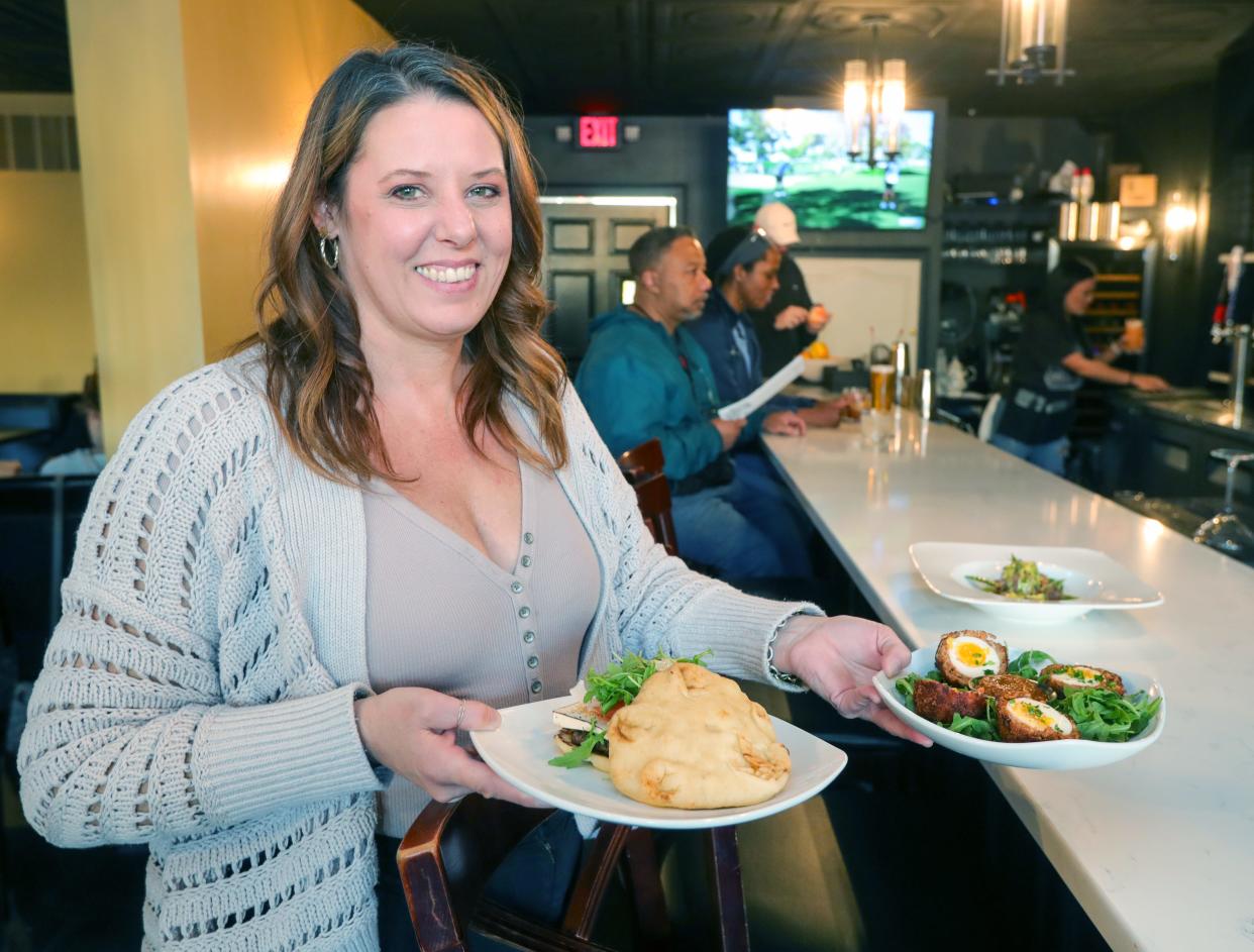 Revival Room owner Gretchen Erb serves up a couple of specialty items from the menu on Friday, Nov. 10, 2023, in Hudson, Ohio. [Phil Masturzo/ Beacon Journal]