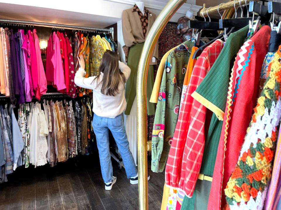 A shopper sifts through the clothing racks at the vintage shop Cotillion Bureau, located on Bow Street in Portsmouth.