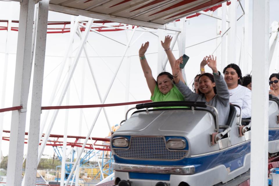 Riders raise hands on the Mouse Trap roller coaster Sunday at Wonderland park in Amarillo.