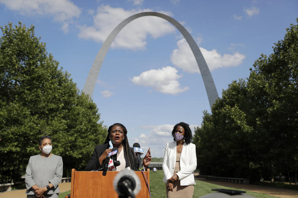 FILE - In this Aug. 5, 2020, file photo, activist Cori Bush, center, speaks as St. Louis Treasurer Tishaura Jones, right, and Circuit Attorney Kim Gardner, left, listen, during a news conference in St. Louis. Bush pulled a political upset on Tuesday, beating 20-year incumbent Rep. William Lacy Clay in Missouri's 1st District Democratic primary. Bush, who led protests after the fatal police shooting of Michael Brown in Ferguson, ousted longtime Rep. William Lacy Clay in Missouri’s Democratic primary, ending a political dynasty that had spanned more than a half-century. Bush said among her first priorities is a more robust COVID-19 relief package that provides greater assistance to families. (AP Photo/Jeff Roberson, File)