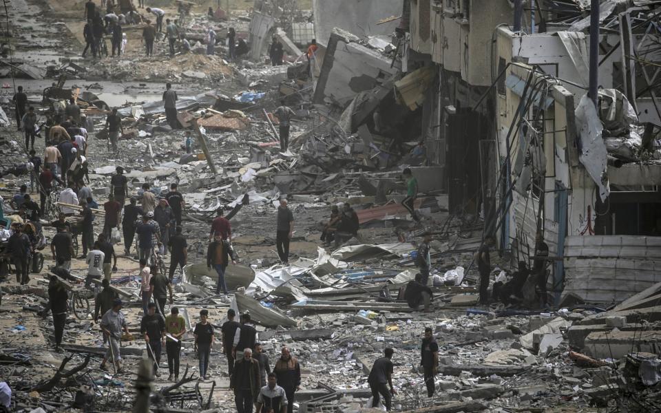 Palestinians return to the Al Nuseirat refugee camp after the Israeli army's week-long assault on the area