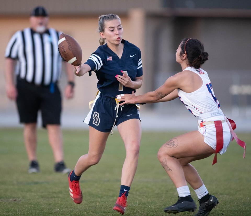 Quarterback Carly Churchward (1) pitches the ball as Destiny Reyes-Downes (12) pressures her during the Pace vs Gulf Breeze flag football at Gulf Breeze High School on Wednesday, March 22, 2023.