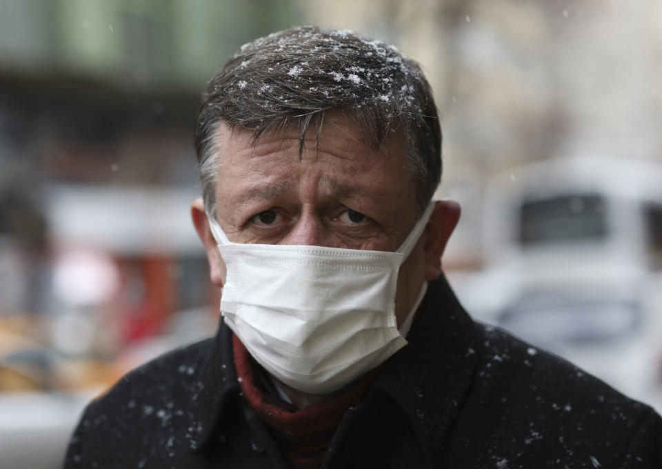 A Turkish man wearing a mask to help protect against the spread of the coronavirus walks in Ankara, Turkey, Friday, March 26, 2021. Daily COVID-19 infections in Turkey surged above 26,000 on Friday, weeks after the government eased restrictions in dozens of provinces under a so-called "controlled normalization" program. (AP Photo/Burhan Ozbilici)