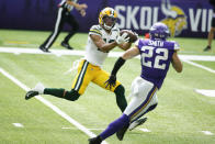 Green Bay Packers wide receiver Allen Lazard (13) catches a pass ahead of Minnesota Vikings free safety Harrison Smith during the second half of an NFL football game, Sunday, Sept. 13, 2020, in Minneapolis. (AP Photo/Bruce Kluckhohn)